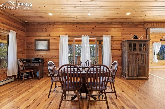 dining space with plenty of natural light, light hardwood / wood-style flooring, and wooden ceiling