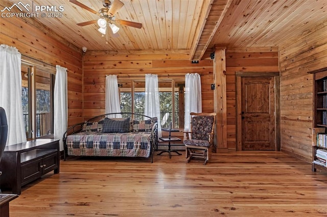 bedroom with wood ceiling, light hardwood / wood-style flooring, and wood walls