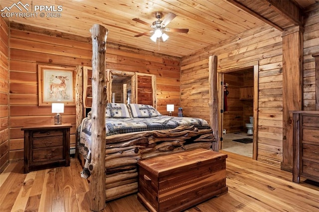 bedroom with connected bathroom, wood walls, light hardwood / wood-style flooring, wooden ceiling, and ceiling fan