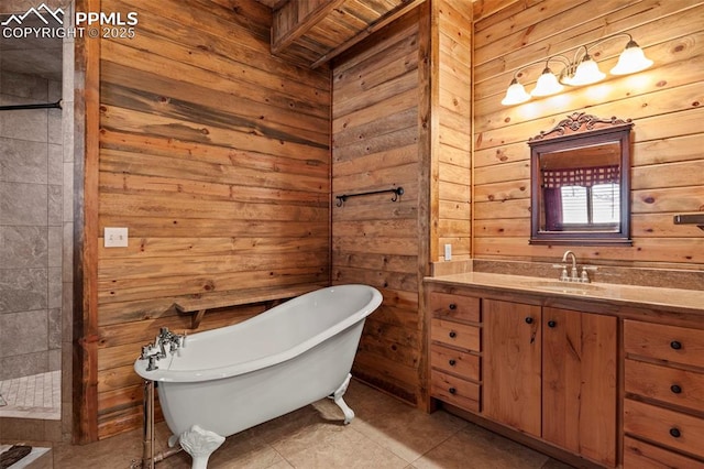 bathroom with vanity, a washtub, tile patterned floors, and wooden walls