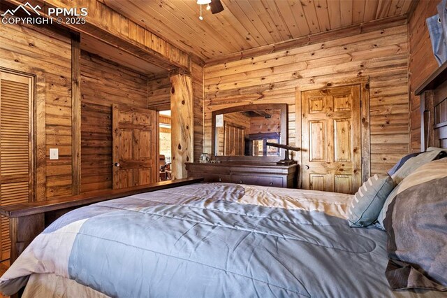 bedroom with wooden ceiling and wood walls