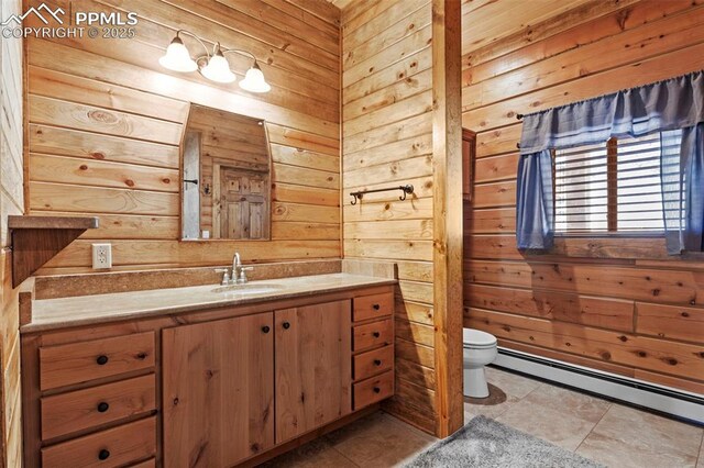 bathroom with toilet, a baseboard heating unit, vanity, and wood walls