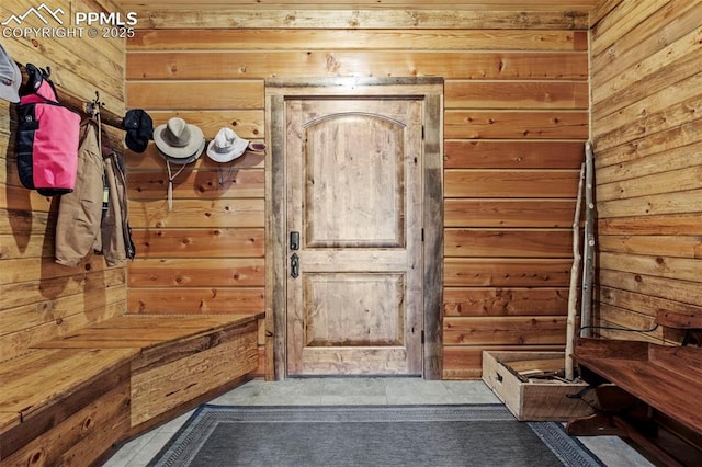 mudroom with wood walls