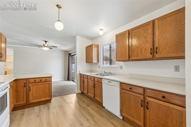 kitchen featuring sink, white appliances, ceiling fan, hanging light fixtures, and light hardwood / wood-style floors