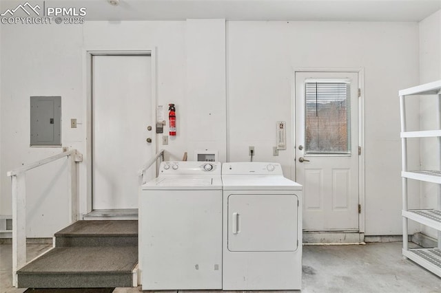 clothes washing area featuring separate washer and dryer and electric panel