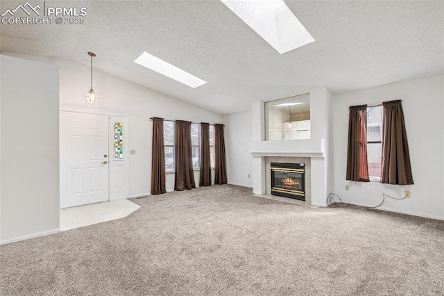 unfurnished living room featuring carpet floors, a tiled fireplace, vaulted ceiling, and a textured ceiling