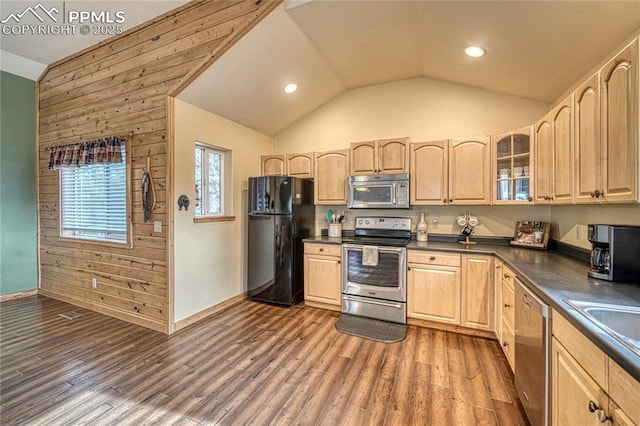 kitchen with stainless steel appliances, dark countertops, dark wood-type flooring, and glass insert cabinets