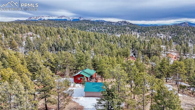 bird's eye view featuring a forest view and a mountain view