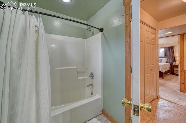 ensuite bathroom featuring shower / bath combination with curtain and connected bathroom