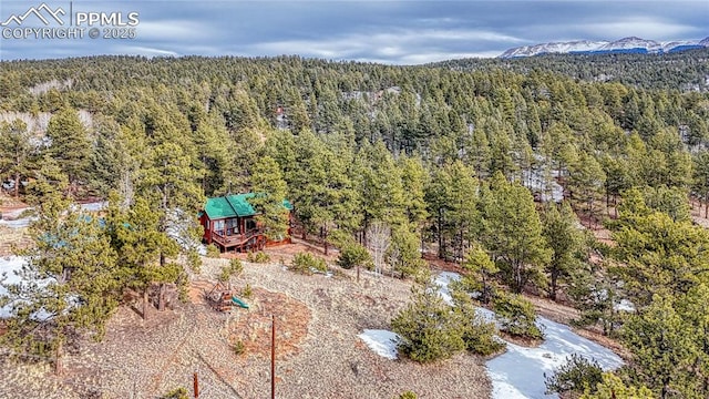 bird's eye view with a mountain view and a wooded view