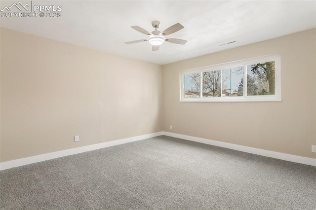 carpeted spare room featuring ceiling fan