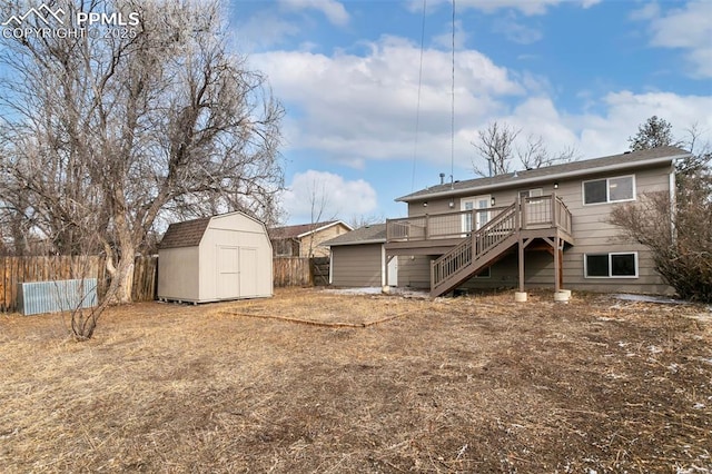 rear view of house with a storage unit and a deck