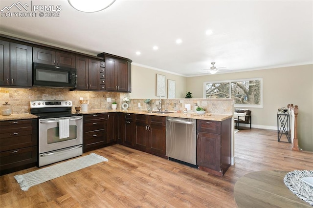 kitchen with dark brown cabinetry, decorative backsplash, stainless steel appliances, and sink