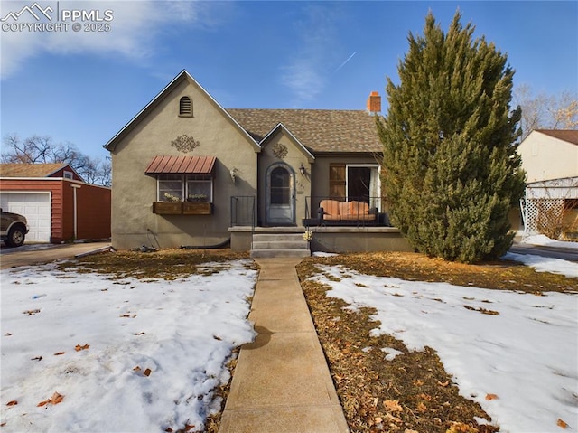 view of front of home with a garage and an outdoor structure