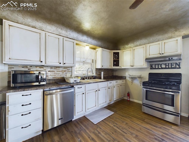 kitchen featuring sink, dark hardwood / wood-style floors, white cabinets, and appliances with stainless steel finishes