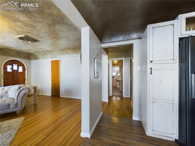 hallway with dark hardwood / wood-style floors