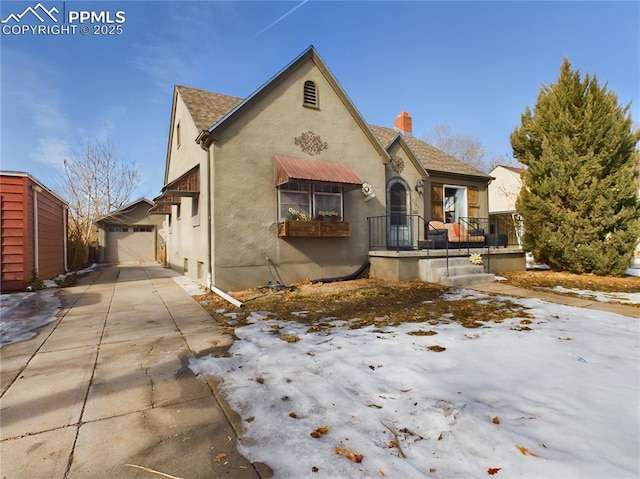 view of front of home with a garage and an outdoor structure