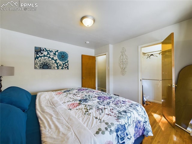 bedroom with hardwood / wood-style floors