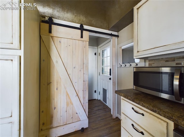 kitchen with dark hardwood / wood-style flooring and a barn door