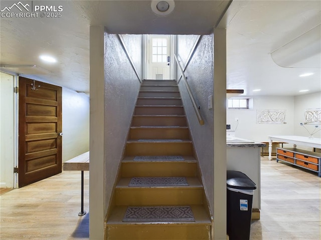 stairs with hardwood / wood-style flooring