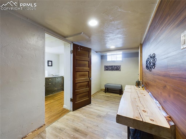 corridor with light hardwood / wood-style floors