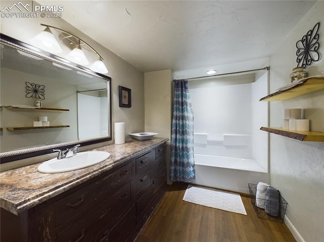 bathroom with shower / bath combination with curtain, vanity, and hardwood / wood-style flooring