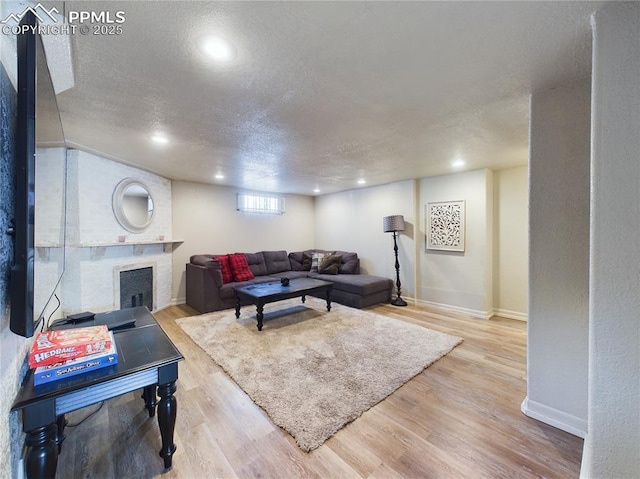 living room featuring light hardwood / wood-style floors and a textured ceiling