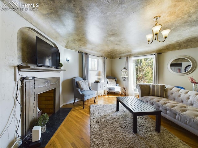 living room with an inviting chandelier and wood-type flooring