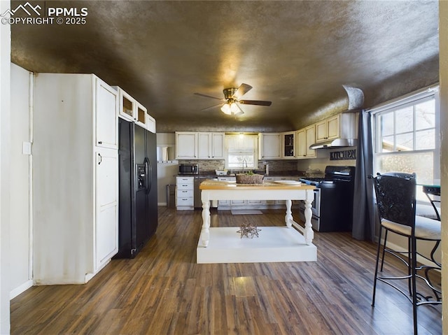 kitchen with tasteful backsplash, white cabinetry, dark hardwood / wood-style floors, ceiling fan, and stainless steel appliances