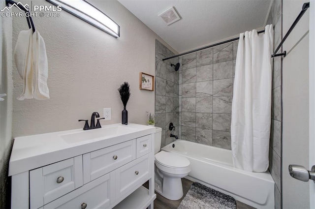 full bathroom with vanity, toilet, shower / bath combo with shower curtain, and a textured ceiling