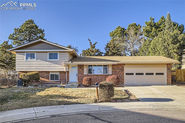 tri-level home with a garage and cooling unit