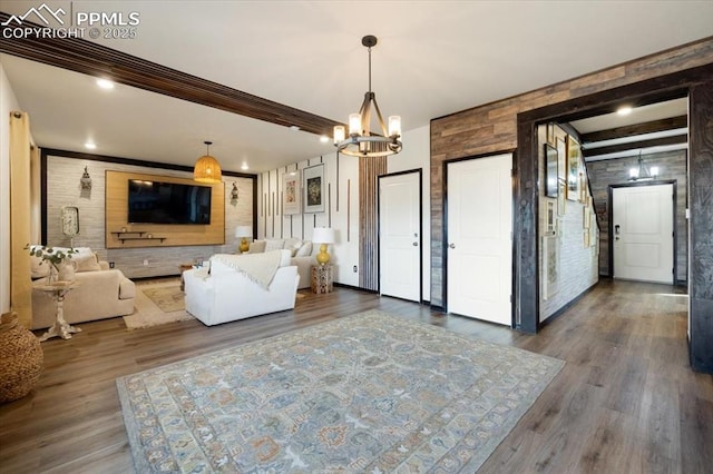 living room featuring dark wood-style floors and an inviting chandelier