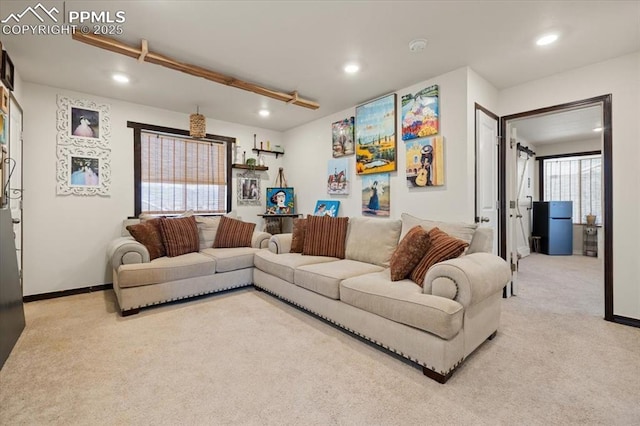 living area featuring recessed lighting, light carpet, and baseboards