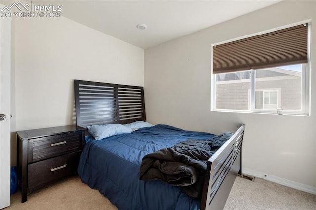 bedroom featuring light colored carpet and baseboards