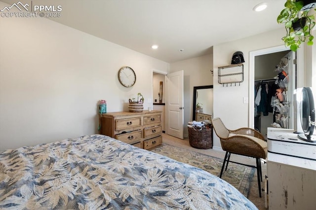 bedroom featuring recessed lighting, light colored carpet, and a spacious closet