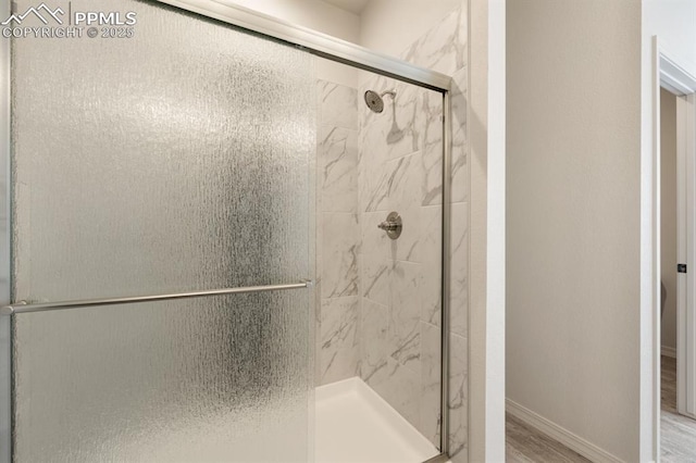 bathroom with wood-type flooring and walk in shower