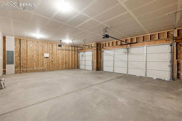 garage with a garage door opener and electric panel