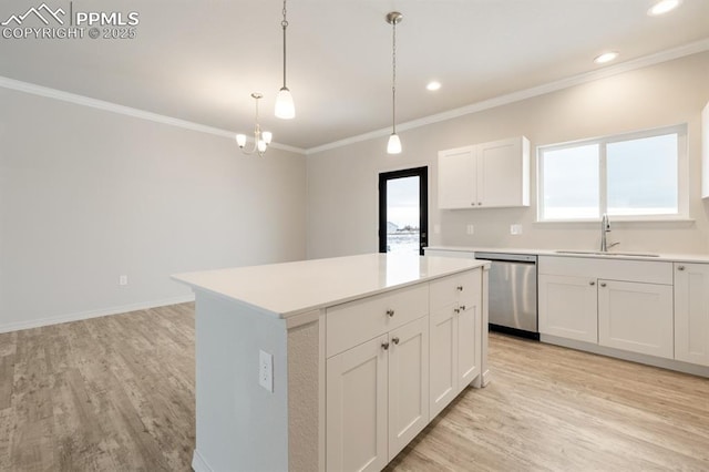 kitchen featuring a kitchen island, pendant lighting, white cabinetry, sink, and stainless steel dishwasher