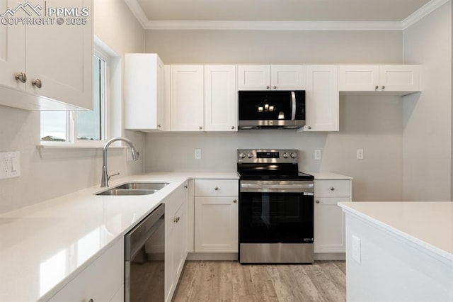 kitchen featuring stainless steel appliances, crown molding, sink, and white cabinets