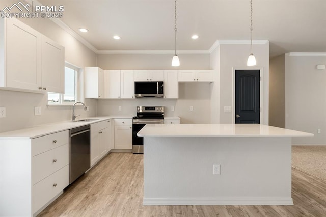 kitchen featuring white cabinetry, appliances with stainless steel finishes, sink, and a kitchen island