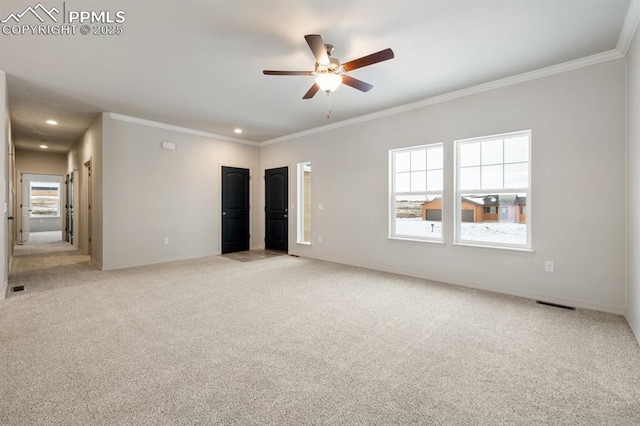 carpeted empty room featuring crown molding and ceiling fan