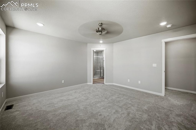 carpeted empty room with a textured ceiling and ceiling fan