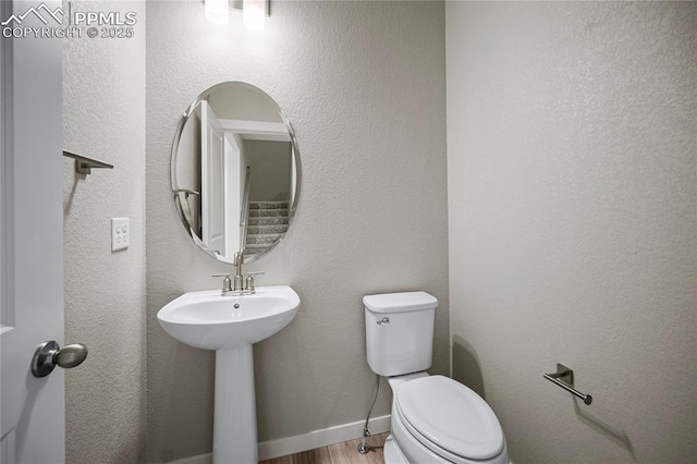 bathroom featuring hardwood / wood-style floors, sink, and toilet