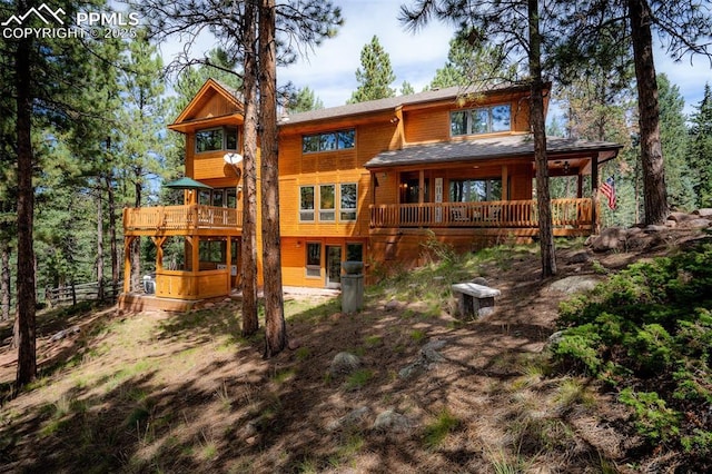 back of property featuring a wooden deck