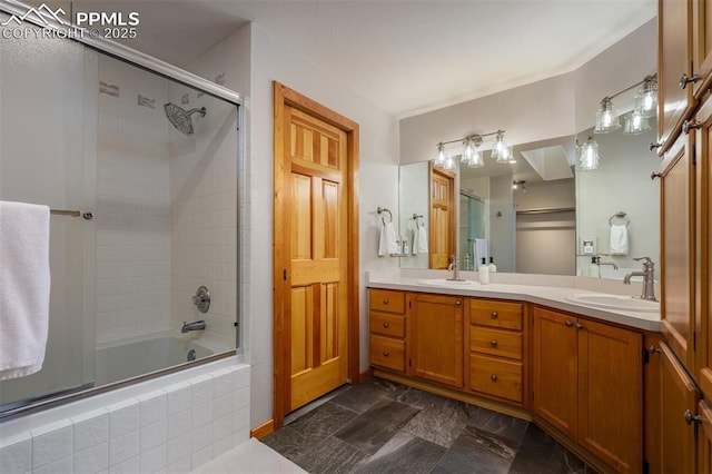 bathroom with vanity and combined bath / shower with glass door