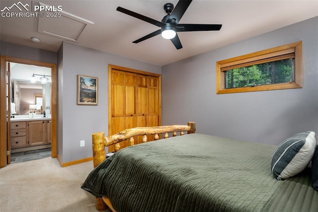 bedroom featuring ensuite bathroom, light colored carpet, and ceiling fan