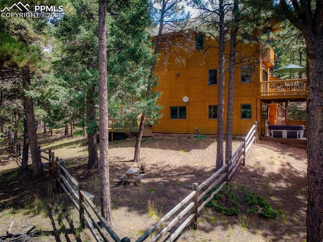 exterior space featuring a hot tub and a deck