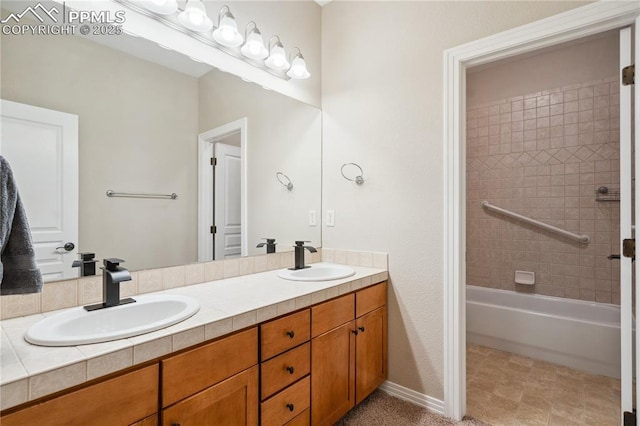 bathroom with vanity and tiled shower / bath combo