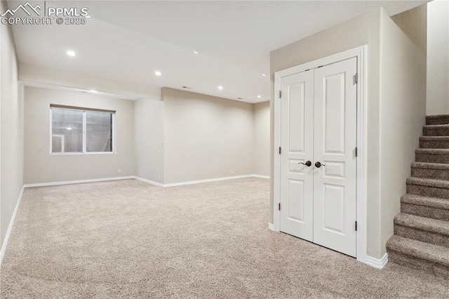 basement featuring light carpet