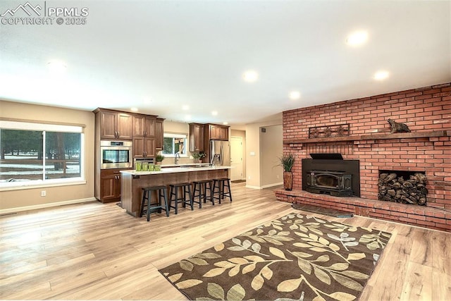 living room featuring light hardwood / wood-style floors and a wood stove